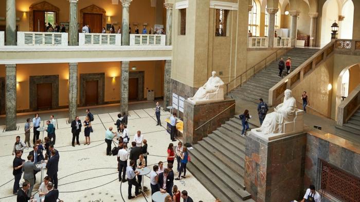 Главный зал Мюнхенского университета Людвига-Максимилиана, где люди разговаривают друг с другом.